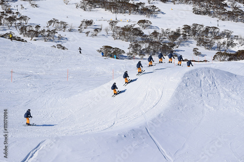 Skier racing and jumping through a Ski Cross Course - racing against the clock in Australia.