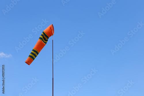 Wind cone against blue sky. Windsock in windless abd perfect flying weather.