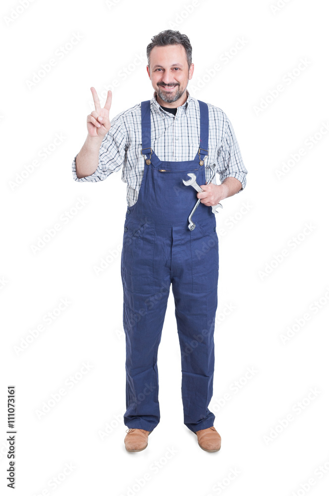 Smiling mechanic with wrench or spanner doing victory gesture Smiling mechanic with wrench or spanner doing victory gesture
