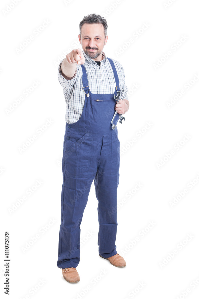 Young mechanic standing and pointing finger at you Young mechanic standing and pointing finger at you