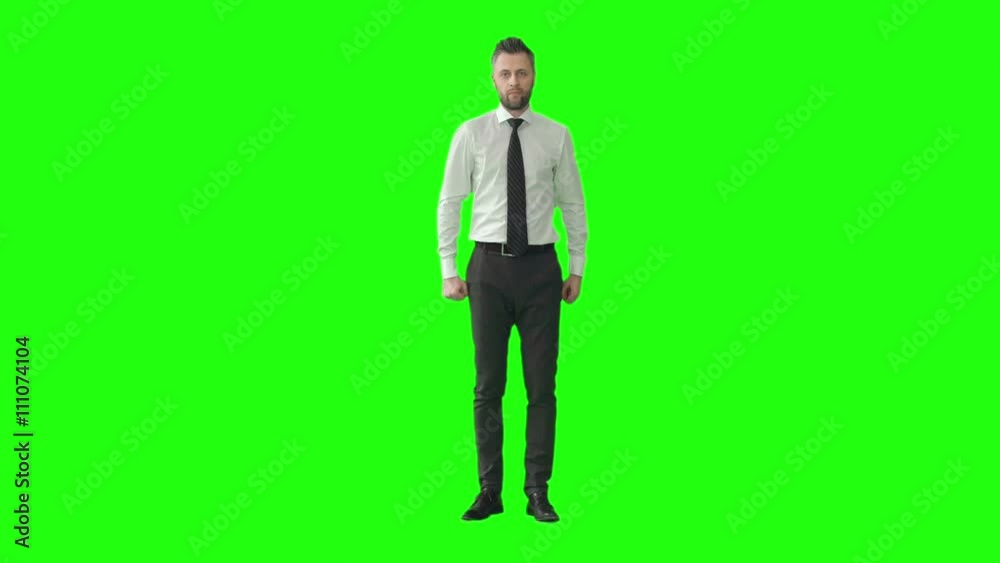 Mid-aged businessman walking towards the camera on green screen background and shouting something with raised arm Mid-aged businessman walking towards the camera on green screen background and shouting something with raised arm