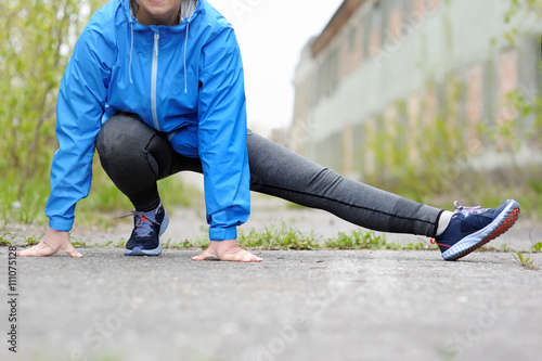 Exercise woman stretching hamstring leg muscles duing outdoor ru photo