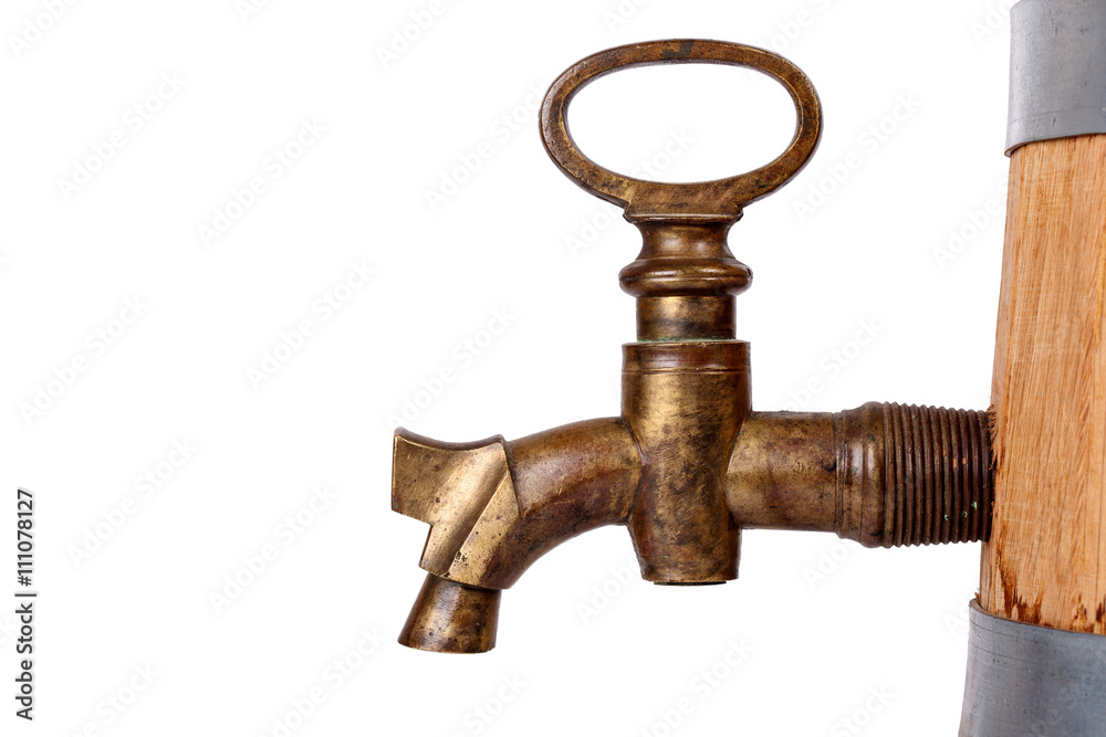 vintage brass faucet in an oak barrel isolated
