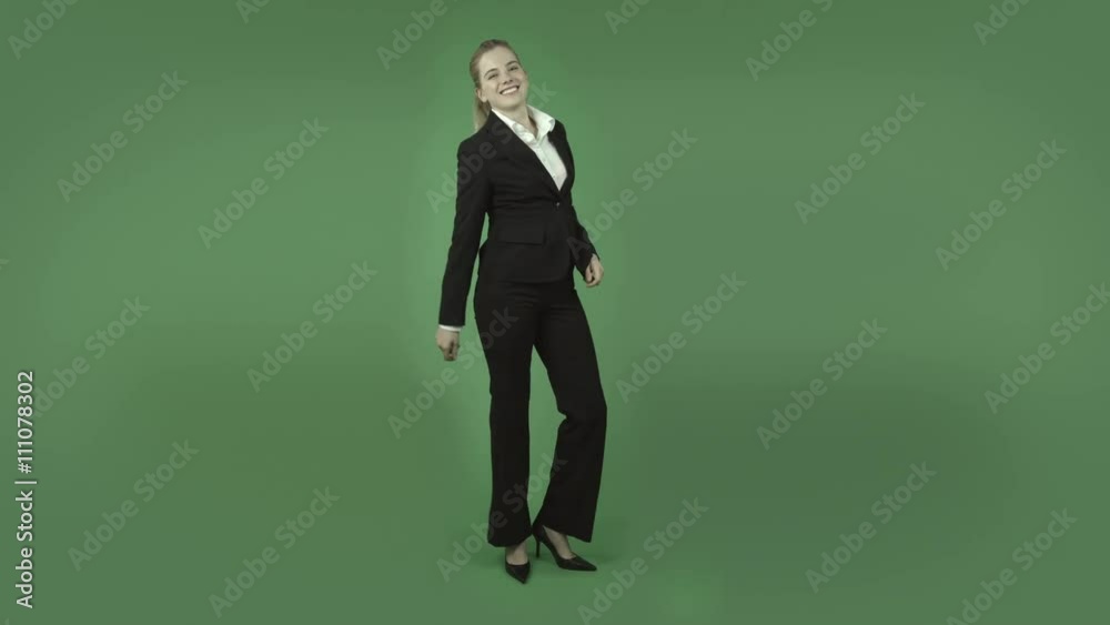 attractive caucasian business girl isolated on green doing a happy dance attractive caucasian business girl isolated on green doing a happy dance