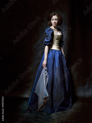 Beautiful girl wearing a medieval dress. Studio works inspired by Caravaggio. Cris. XVII