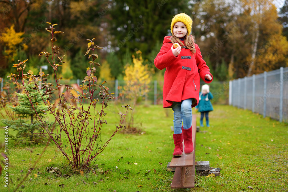 Cute little girl having fun on beautiful autumn day Cute little girl having fun on beautiful autumn day
