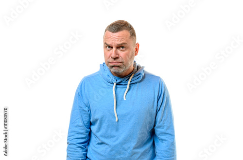 Foto Grumpy man in blue sweater near white wall