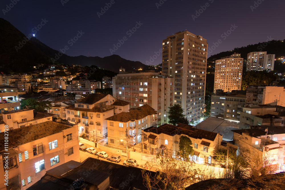 Apartment buildings and houses between hills of Rio de Janeiro in Laranjeiras district at night