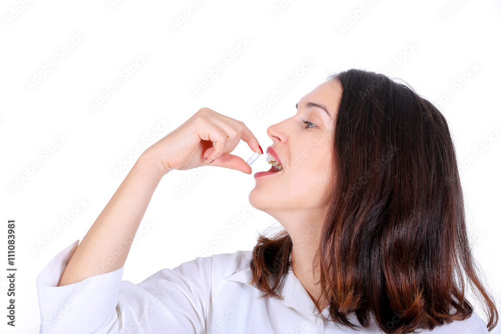 woman taking medicine capsule isolated on white background woman taking medicine capsule isolated on white background
