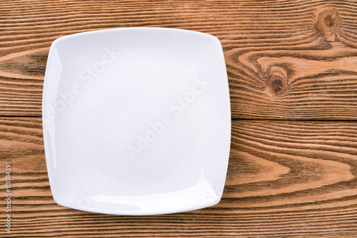 A square plate on a wooden background 