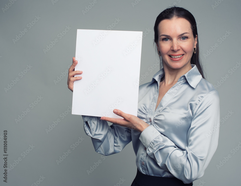 cheerful brunette woman holding a white blank poster cheerful brunette woman holding a white blank poster