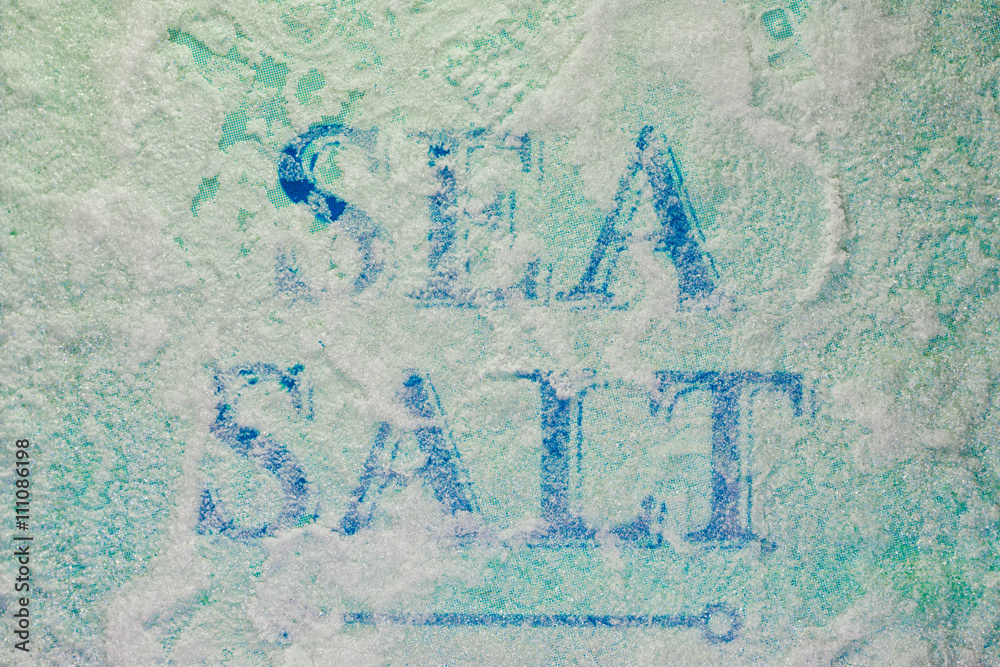 The inscription Sea Salt covered with close up salt crystals The inscription Sea Salt covered with close up salt crystals