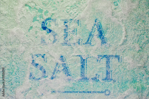 The inscription Sea Salt covered with close up salt crystals © lanalight