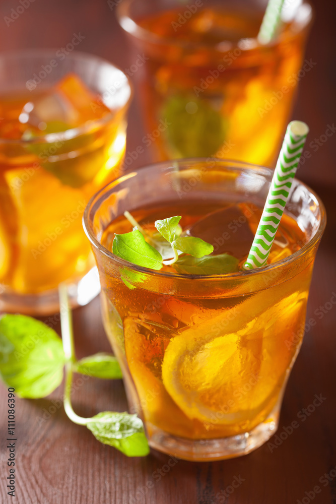 ice tea with lemon and mint on dark rustic background ice tea with lemon and mint on dark rustic background
