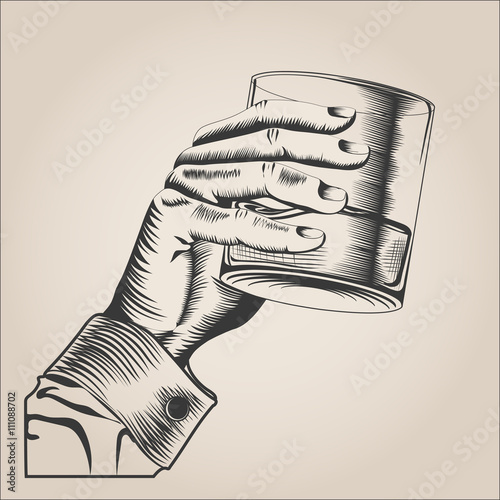 Male hand holding glass alcohol drink