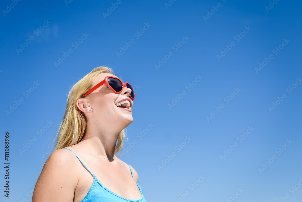 Beautiful young lady watching movie with 3D glasses, blue light background. Beautiful young lady watching movie with 3D glasses, blue light background.