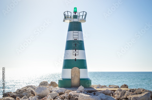 Beautiful lighthouse with calm ocean water background. sunny day outdoors photo