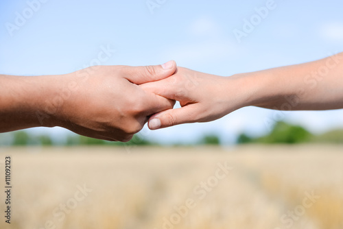 Handshake on outdoors blurred abstract nature background, image closeup  © gorosi