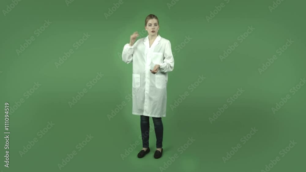 attractive caucasian girl with lab coat isolated on green talking and pointing attractive caucasian girl with lab coat isolated on green talking and pointing