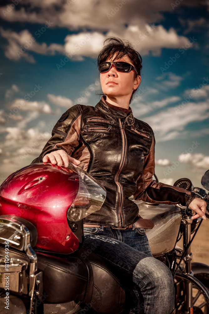 Biker girl sitting on motorcycle
