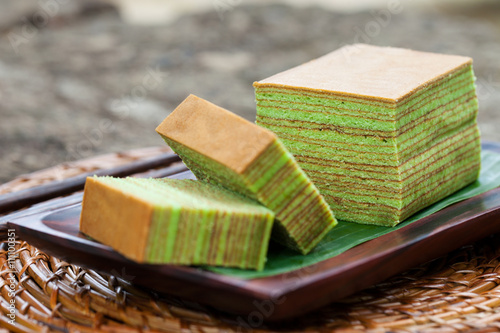 Traditional Indonesian sweet Lapis layer cake on a wooden background.