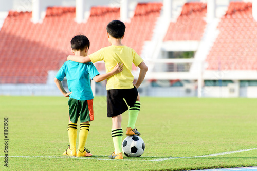 Boy and football in the football grass field