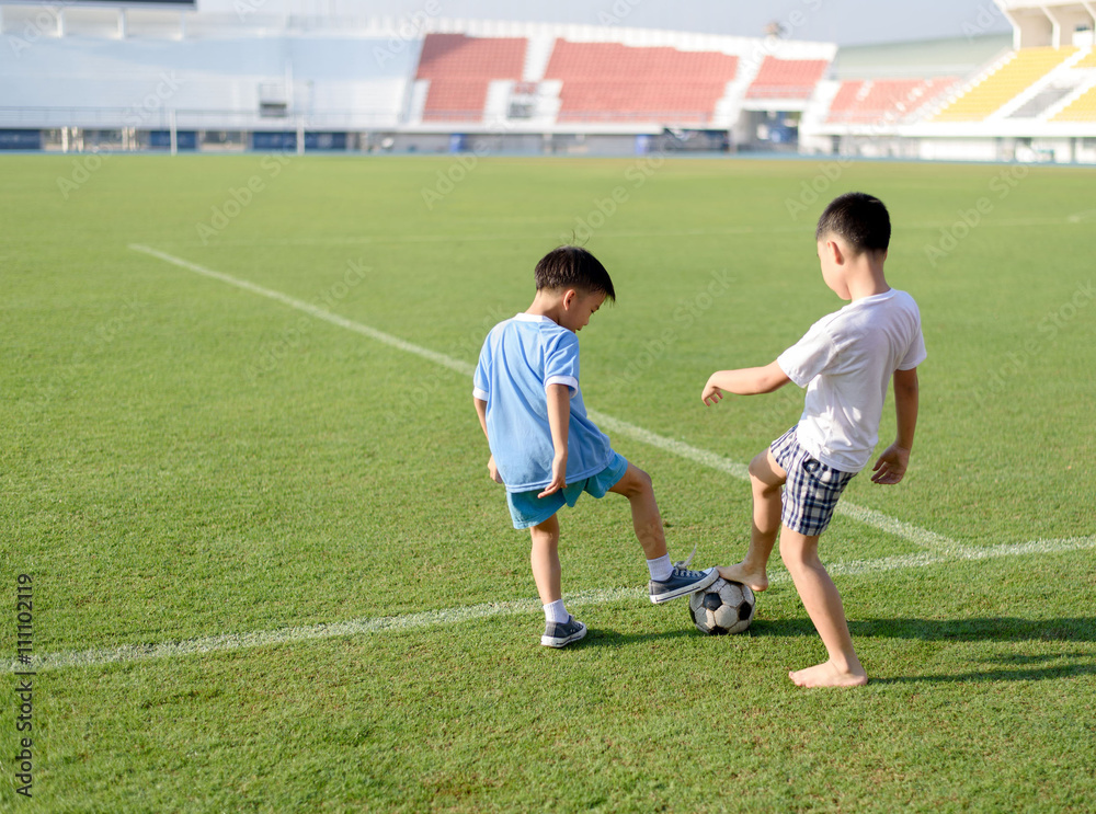 Boy play football on the lawn