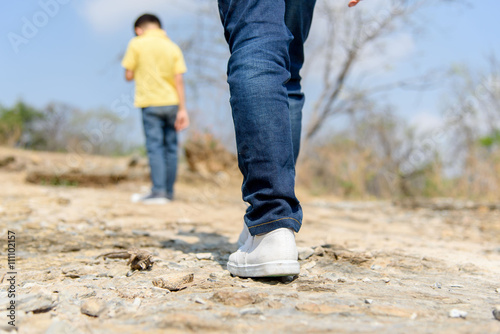 Two Boy walking on the rocky land. © TinPong