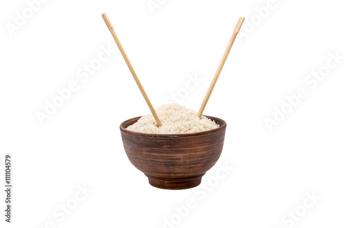 Bowl of raw rice with chopsticks isolated on white