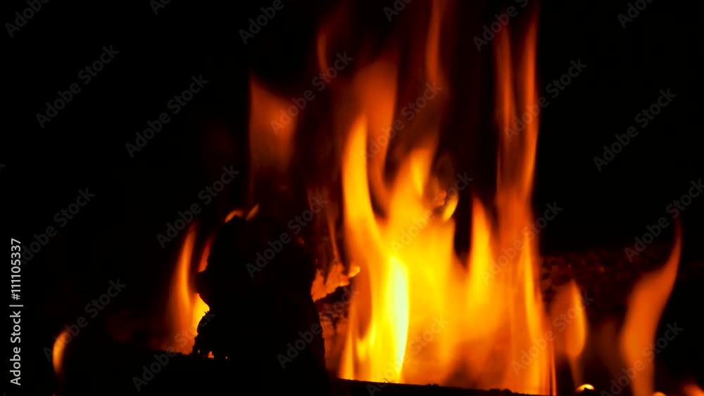 Fire is burning in a rustic wood stove. Flame heats the rural farmhouse. Fire is burning in a rustic wood stove. Flame heats the rural farmhouse.