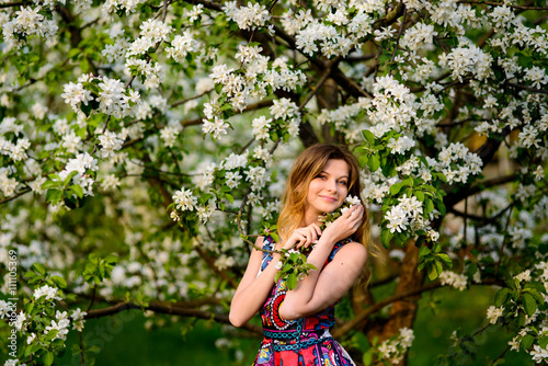 Beautiful woman in blooming garden