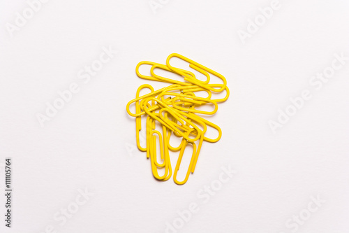 Yellow paperclips on white background