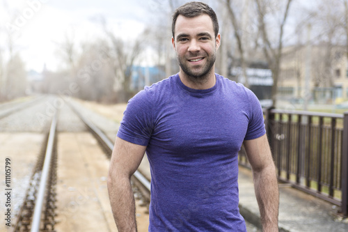 nice young man portrait on the railroad