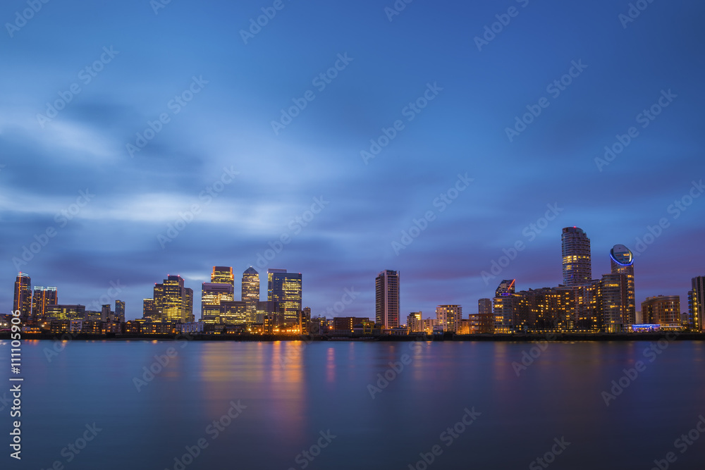 London, UK - The famous business district and skyscrapers of Canary Wharf at blue hour