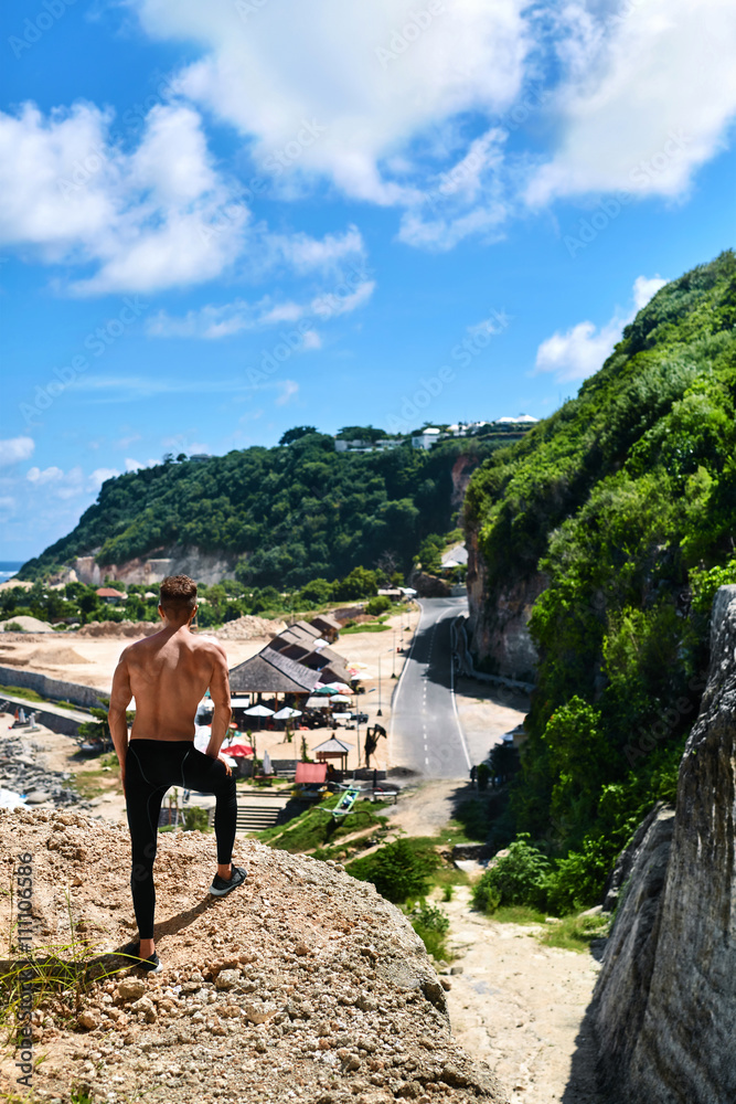 Fitness Male Hiker Standing On Top Of High Rocky Hill On Hot Sunny Summer  Day. Topless