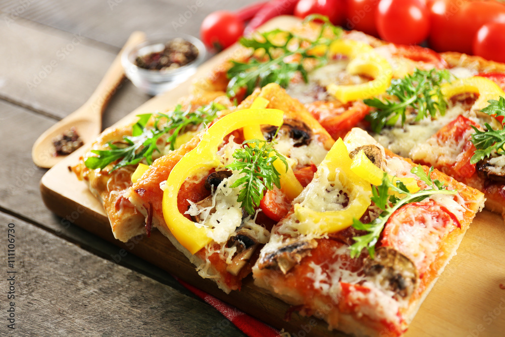 Pieces of delicious pizza on the table, close-up Pieces of delicious pizza on the table, close-up