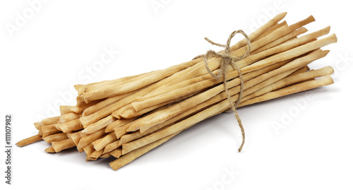 Photos Crispy crunchy long bread sticks tied with rope, isolated on a white background