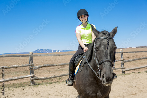 Beautiful teen girl on the farm with her horse.