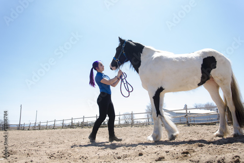Beautiful teen girl on the farm with her horse. © Louis-Photo