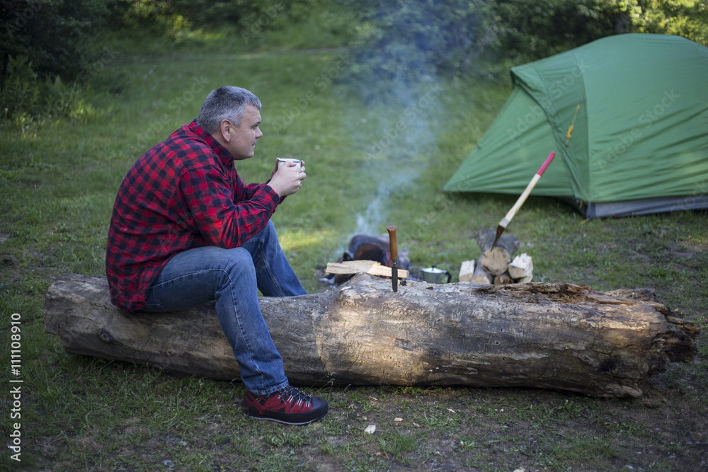 Man cooks the coffee on the fire. Man cooks the coffee on the fire.