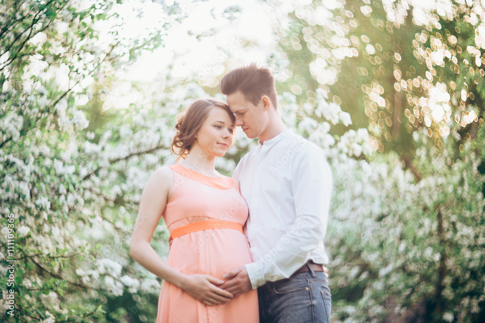 Couple in love under blooming branches spring day. Couple in love under blooming branches spring day.