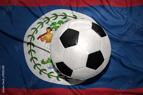 black and white football ball on the national flag of belize