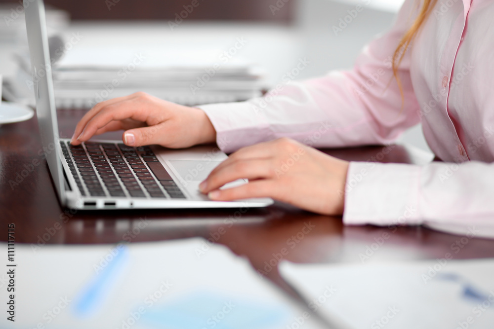 Close up of business woman hands typing on laptop computer Close up of business woman hands typing on laptop computer