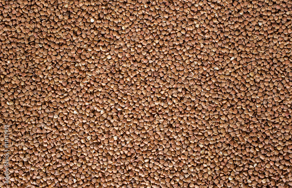 Fototapeta premium Raw buckwheat groats close-up, background, texture