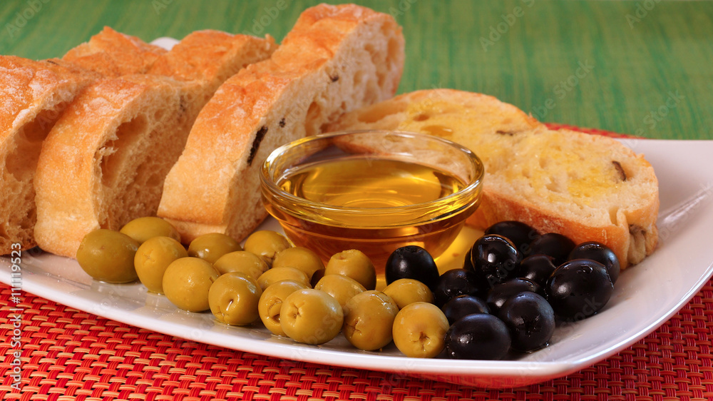 Green and black olives, a bowl with olive oil and homemade bread... Green and black olives, a bowl with olive oil and homemade bread...