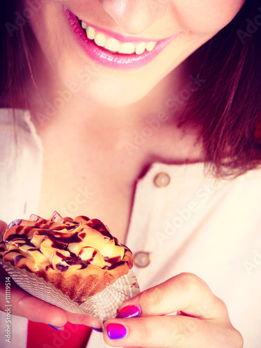 Smiling woman holds cake in hand