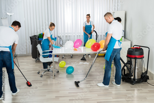 Janitors Cleaning The Office After Party