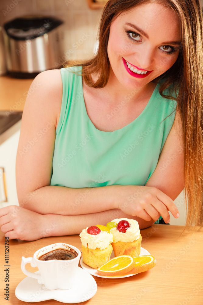 Woman with coffee and cake in kitchen. Gluttony. Woman with coffee and cake in kitchen. Gluttony.