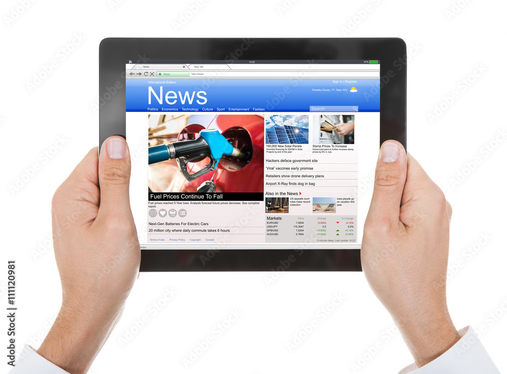 Person's Hand Holding Digital Tablet With News On Screen Person's Hand Holding Digital Tablet With News On Screen