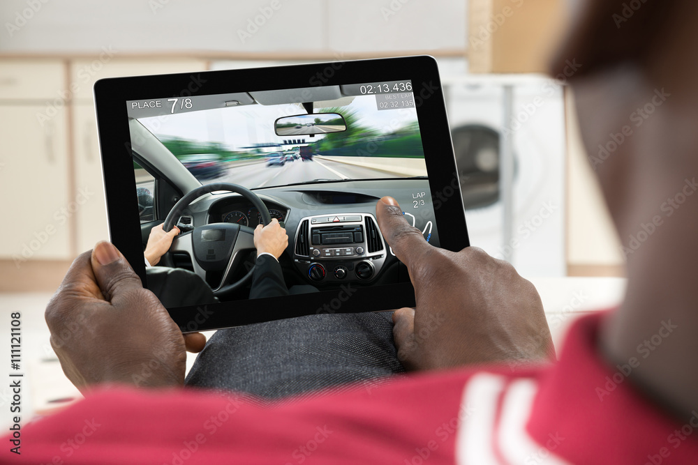 Man Using Digital Tablet To Play Game